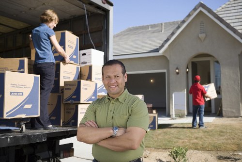 Team unpacking and setting up items in a new home